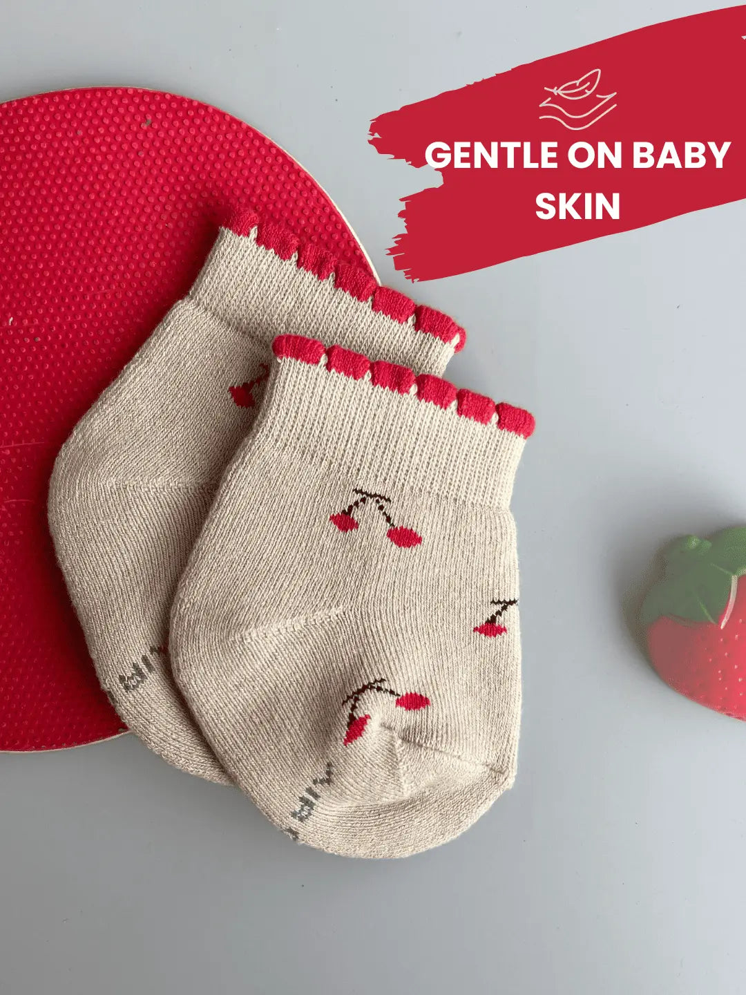 Air Garb brand baby combo socks for infants; a 6-pair set of soft cotton socks featuring pineapple, watermelon, cherry, and cute character face designs in vibrant colors like yellow, red, and blue.